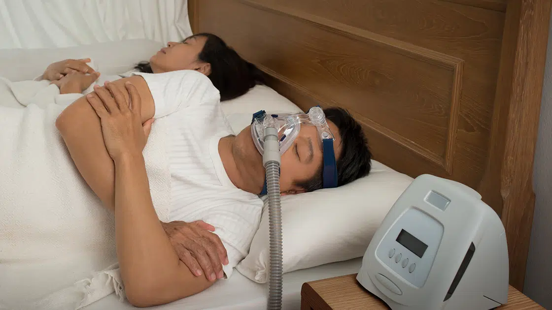 person sleeping with CPAP machine
