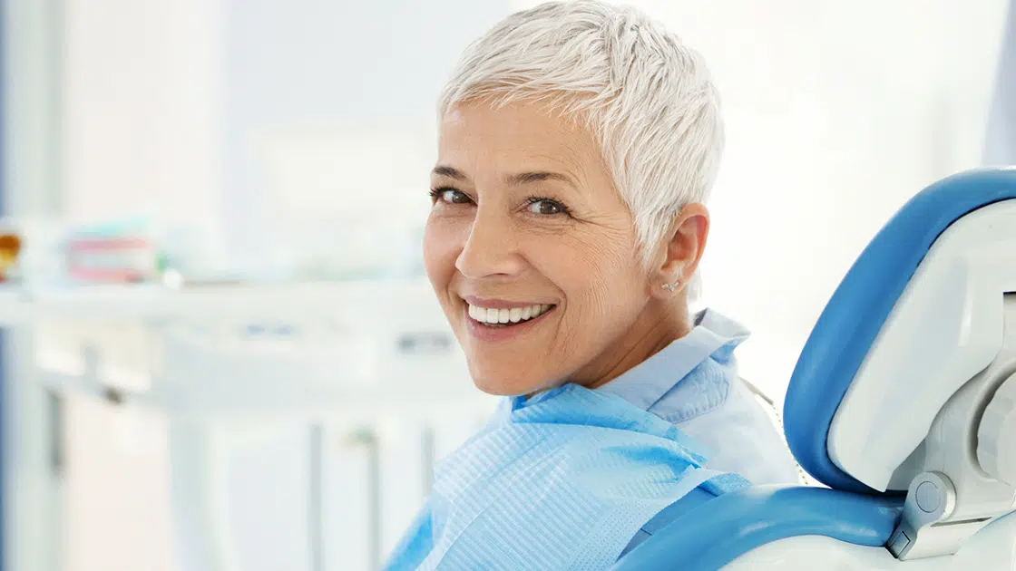 Smiling Mature Woman in Dental Chair